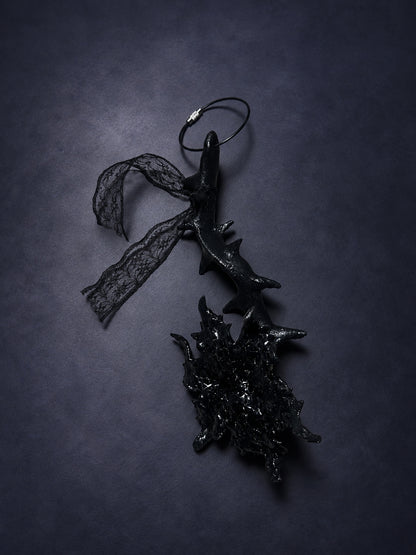 Black Thorn Bloom Talisman with a thorned stem, textured bloom, black lace and attachment loop, shown in full.