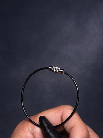 Closed black attachment loop and silver-toned connector on Thorn Bloom Talisman.